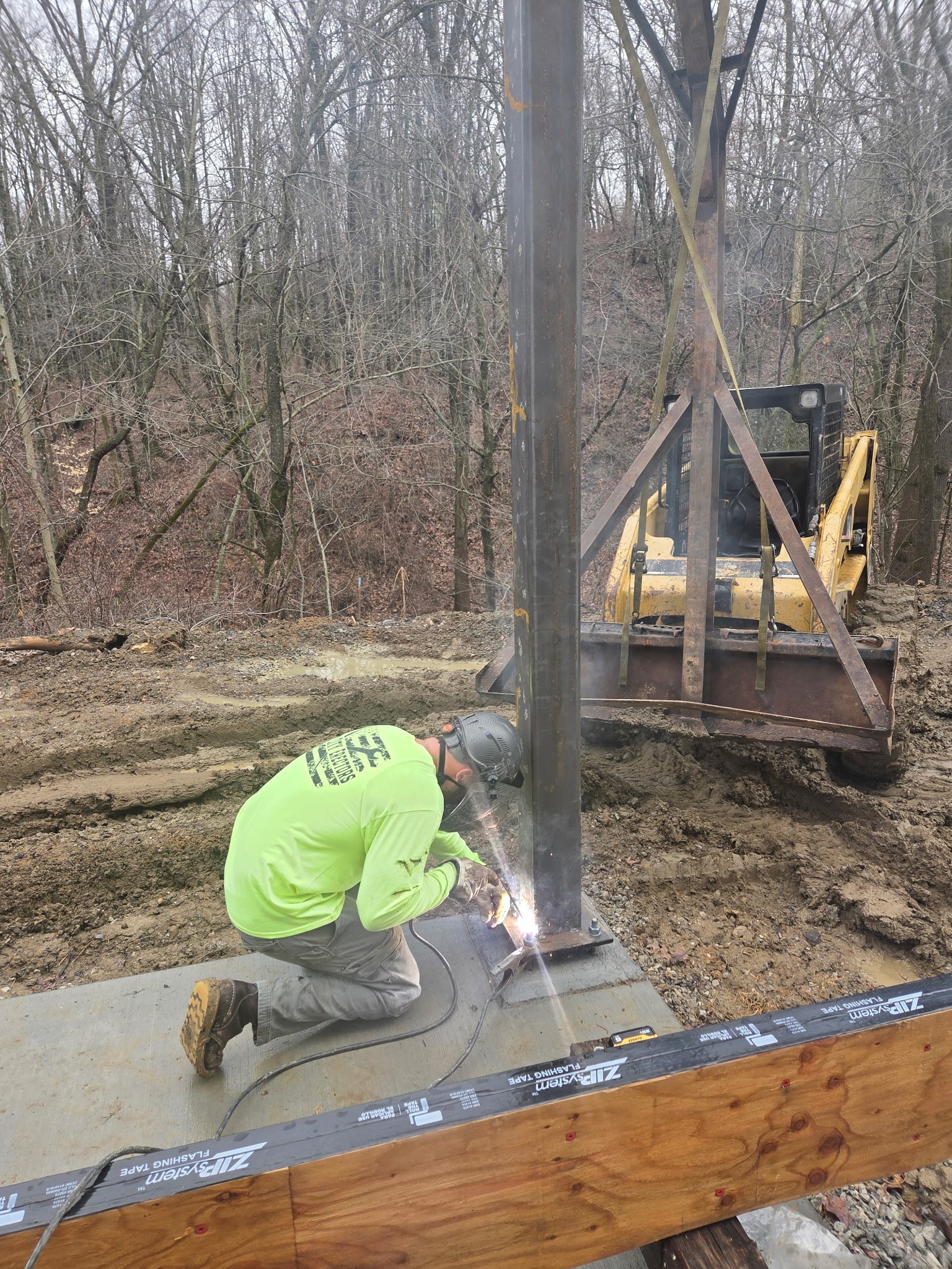 Technician welding and repairing a farm gate on-site